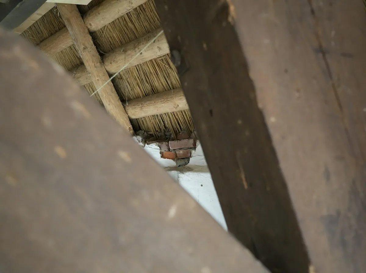 Roof Replacement in Rialto — a timber roof beam in close-up inside an attic