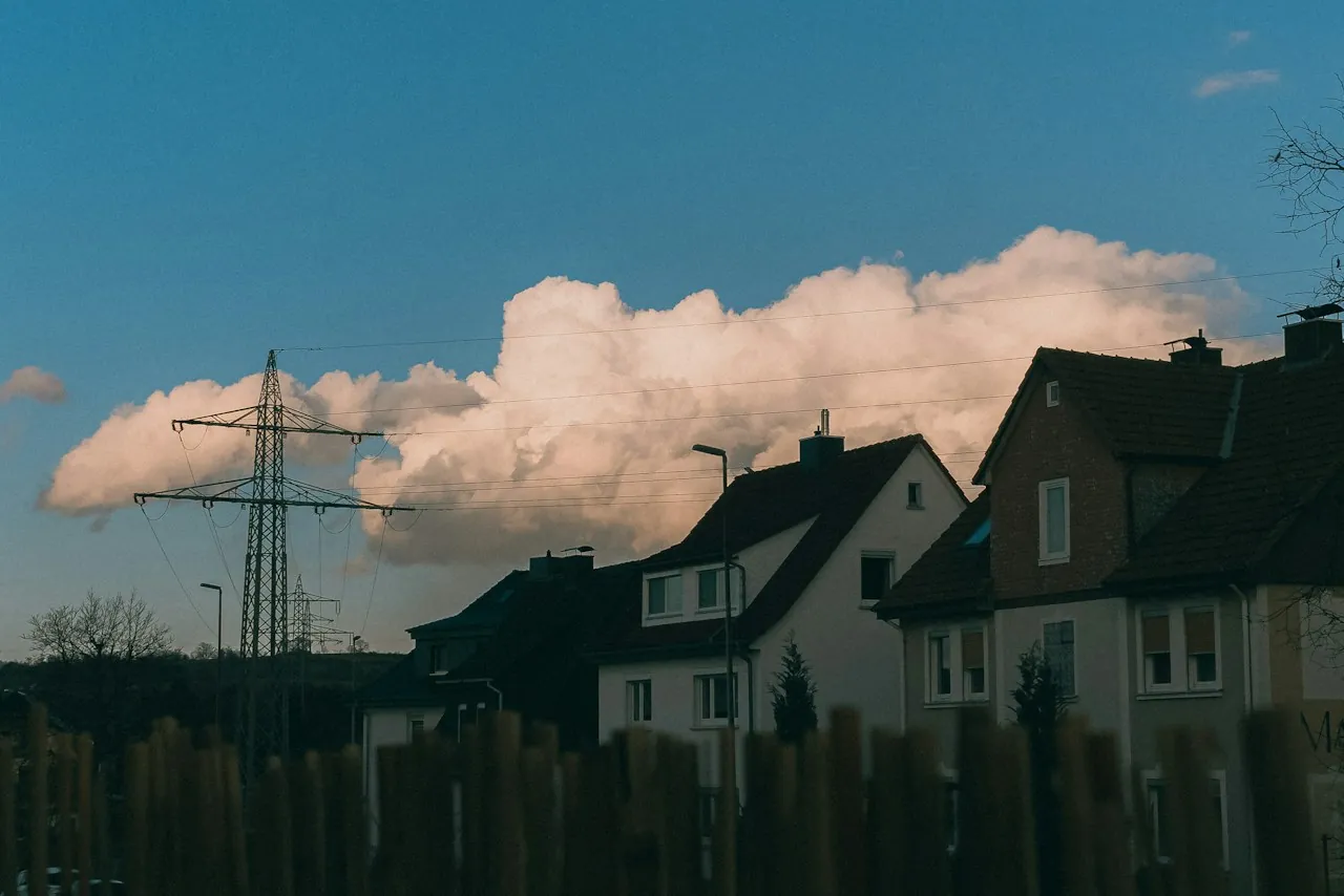 Roof Replacement in Rialto — towering clouds over rooftops and power lines