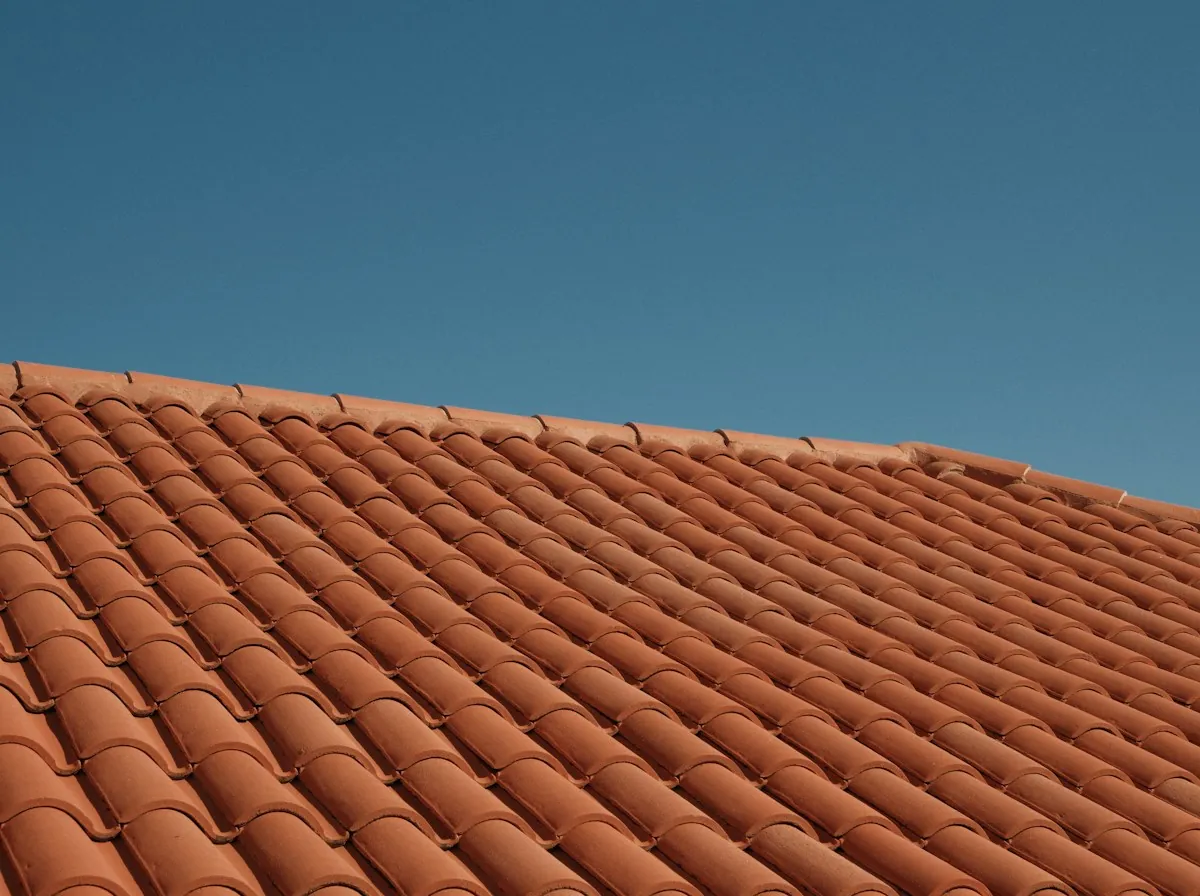 Tile Roof Replacement in Rialto — a terracotta tile roof against a blue sky